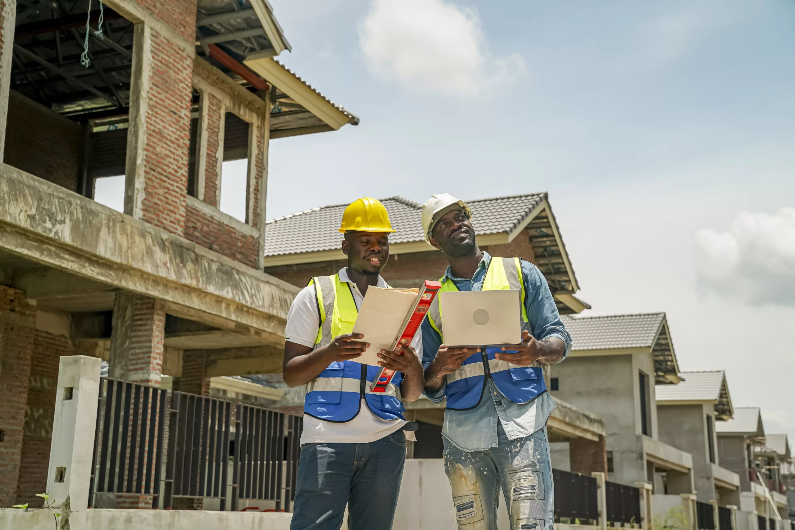 construction-workers-review-plans-on-site-at-a-building