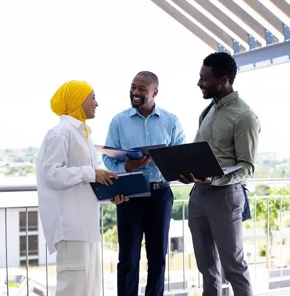 diverse-real-estate-team-discussing-project-outdoors