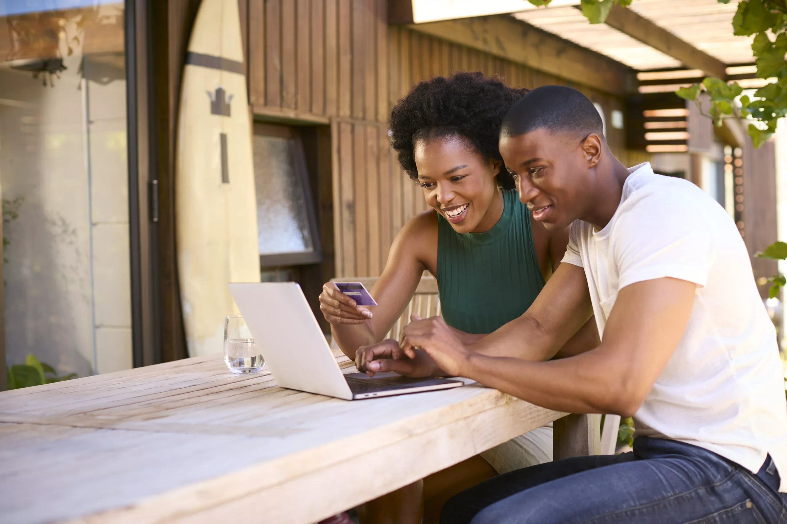 excited-couple-with-credit-card-using-laptop