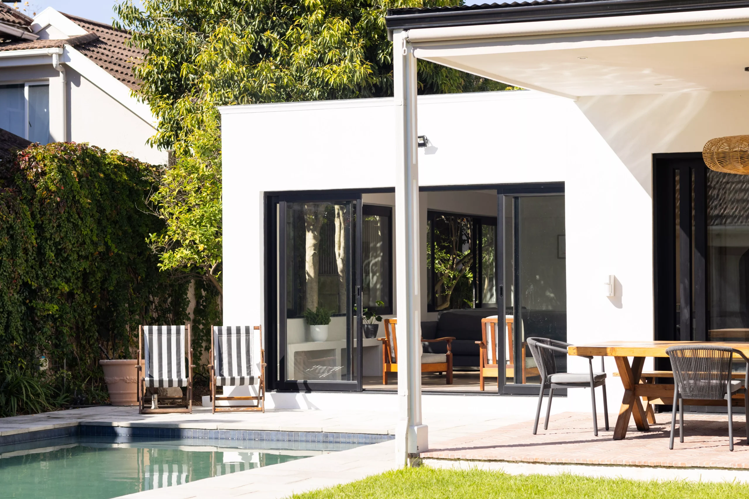 modern-backyard-with-pool-lounge-chairs-and-outd