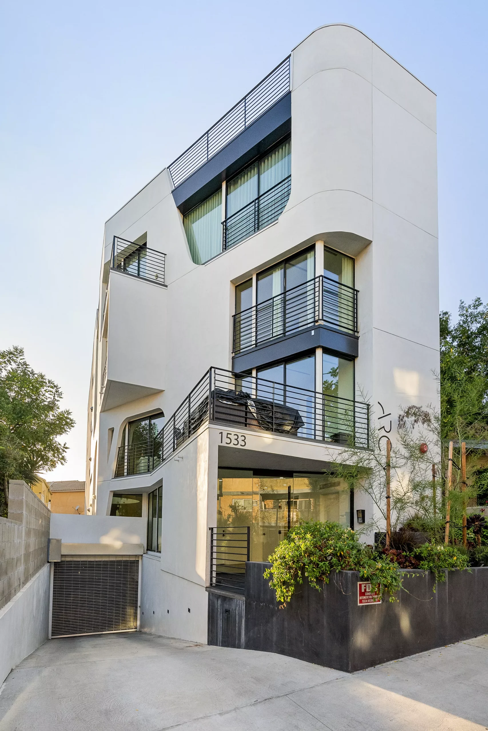 white-walled-house-with-black-balconies-and-railin