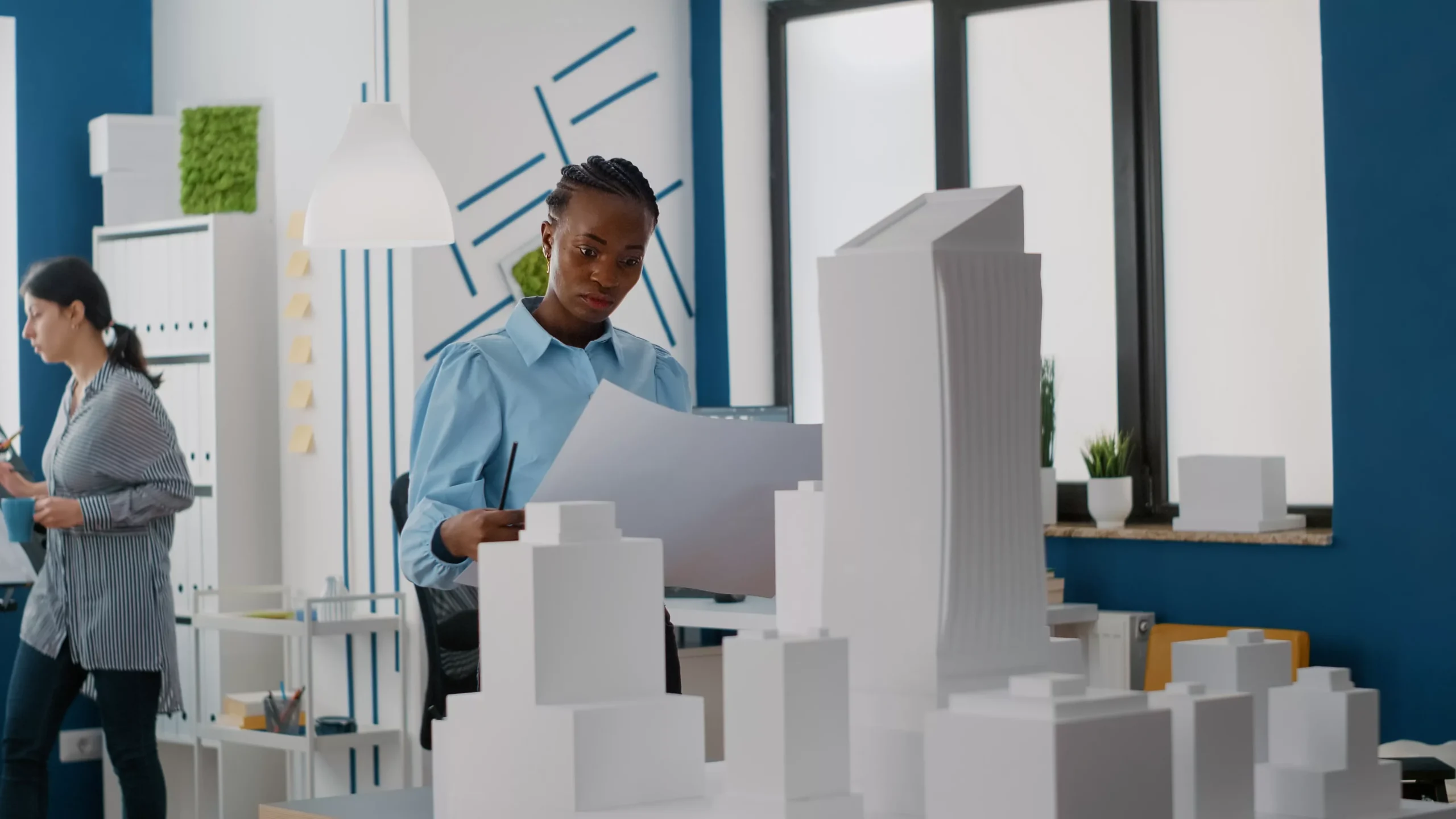 woman-builder-analyzing-blueprints-plans