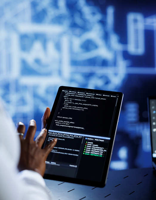 Hand holding a tablet displaying code against a blue tech background
