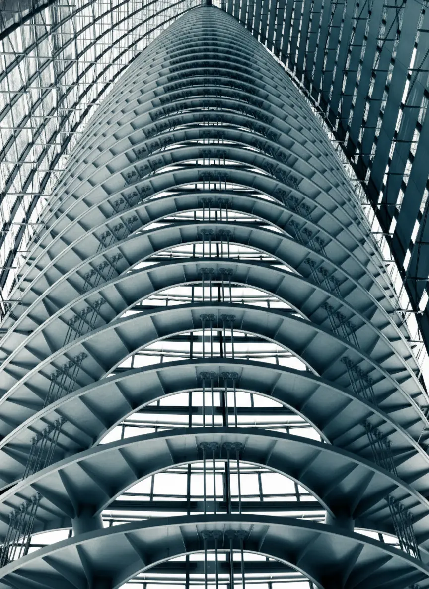 Low-angle view of a modern skyscraper with curved architectural facade