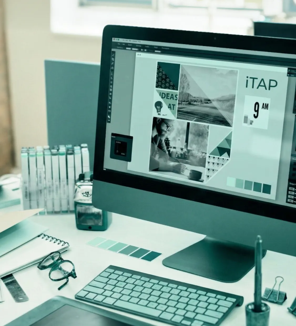 Designer workstation with branding mockup displayed on screen