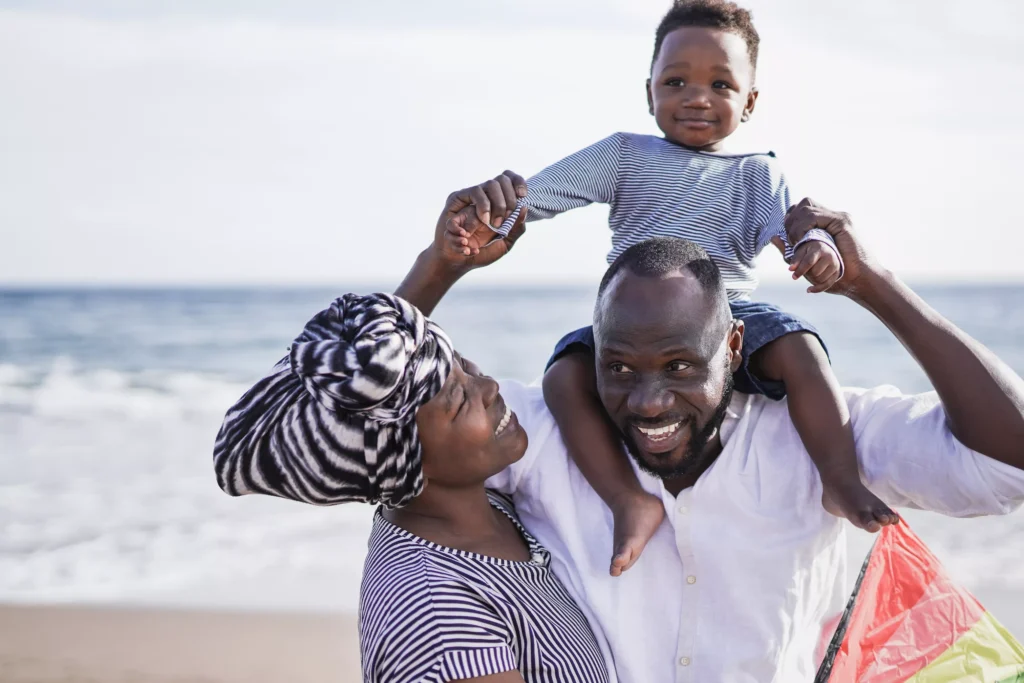 african-father-with-little-son-on-his-shoulder-out