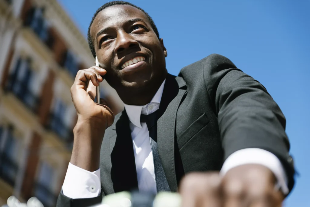 african-man-with-mobile-phone-and-bicycle