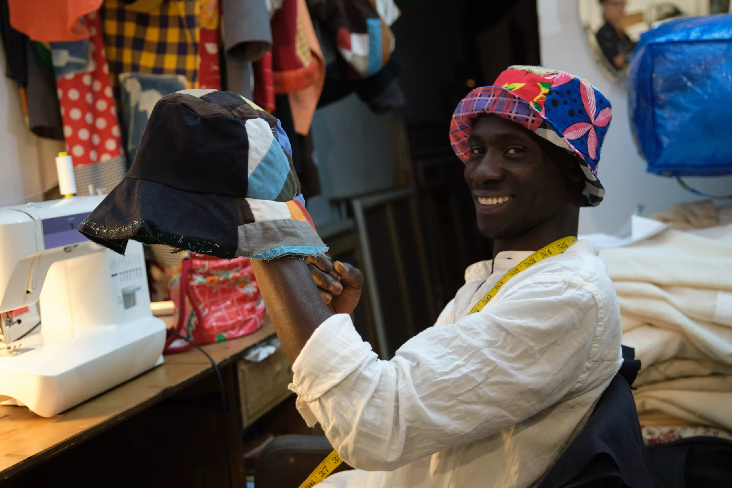 black-tailor-smiling-and-looking-at-camera