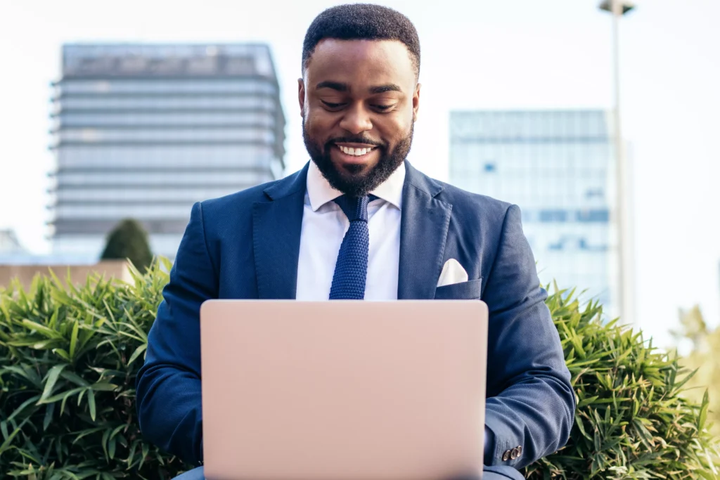 business-black-man-in-suit-working-with-laptop-out