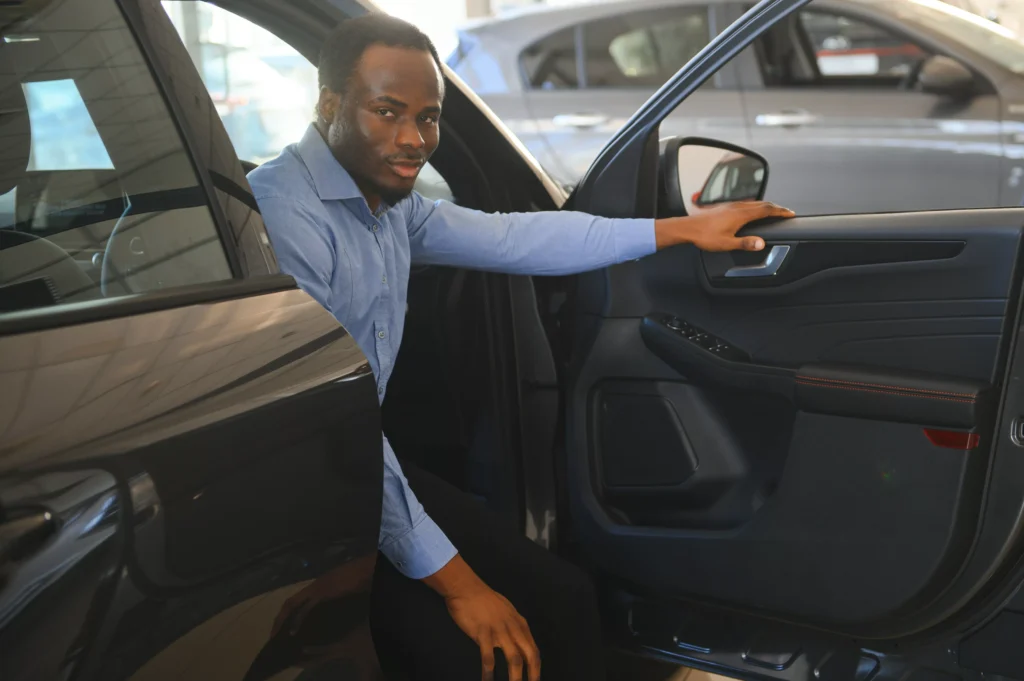 car-buyer-black-guy-choosing-new-automobile-in-de