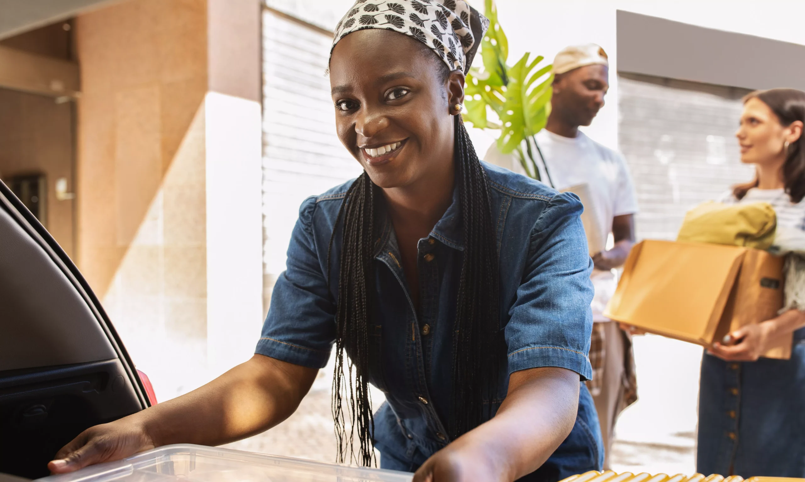 cheerful-african-american-woman-packing-stuff-to-a