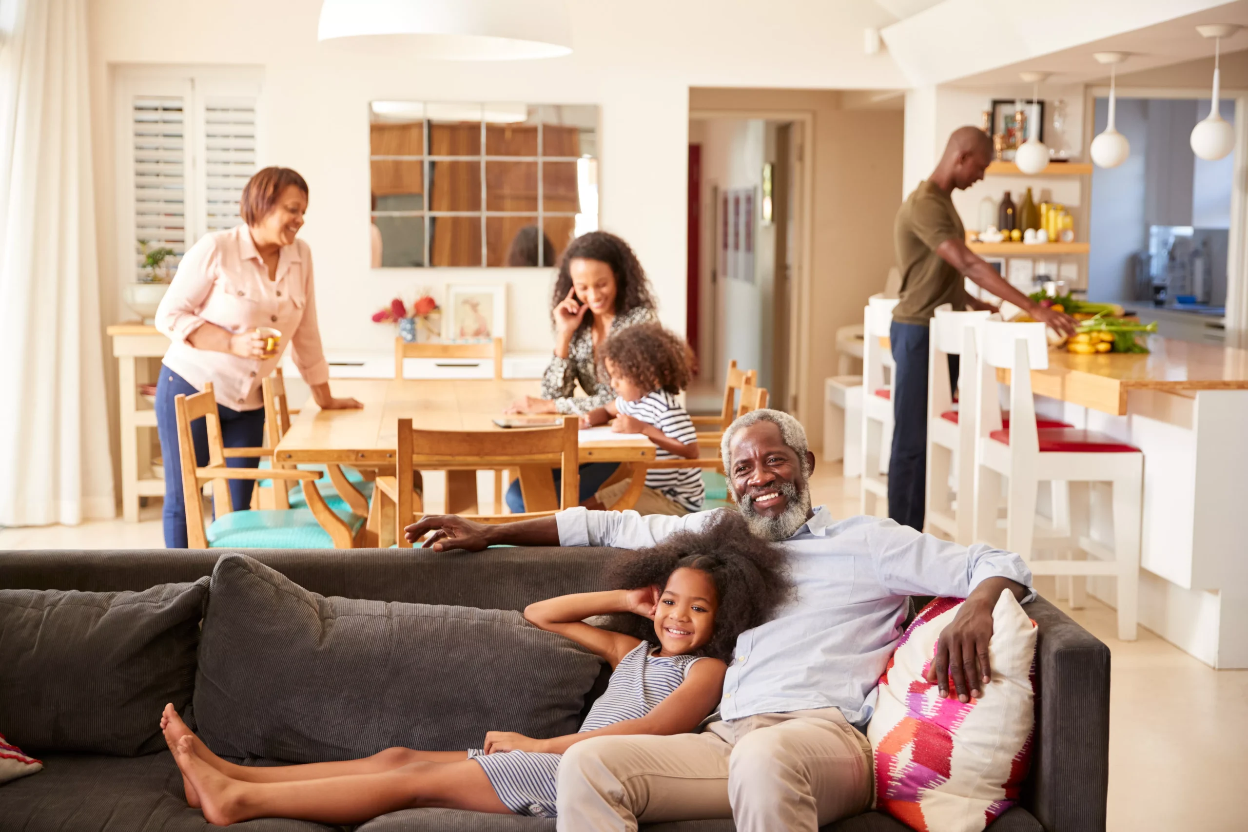 grandfather-with-granddaughter-sitting-on-sofa