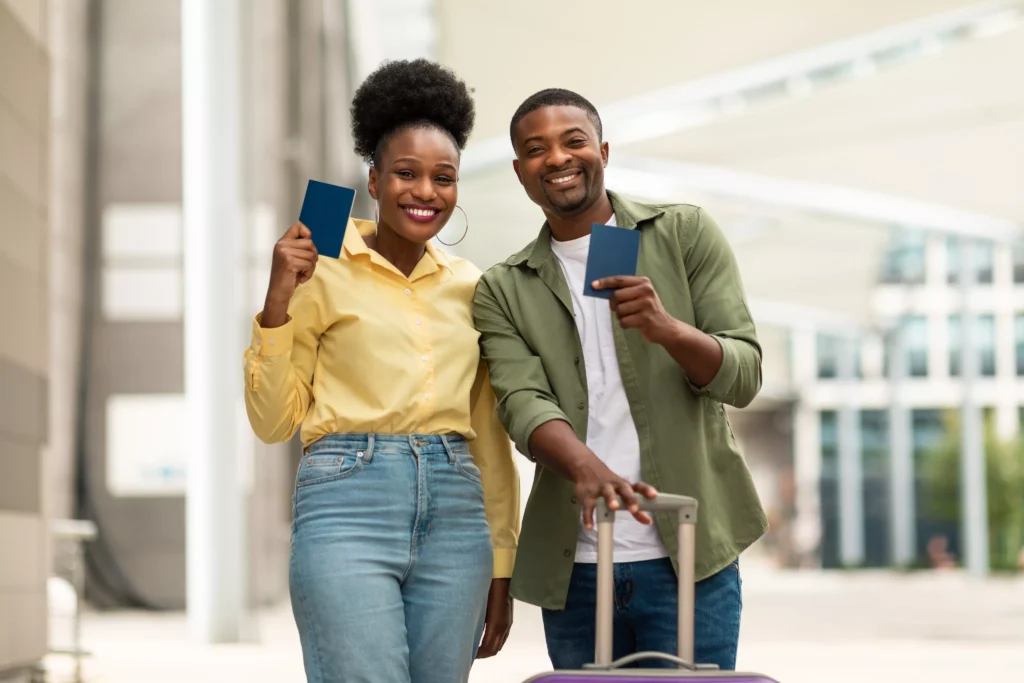 happy-black-spouses-showing-passports