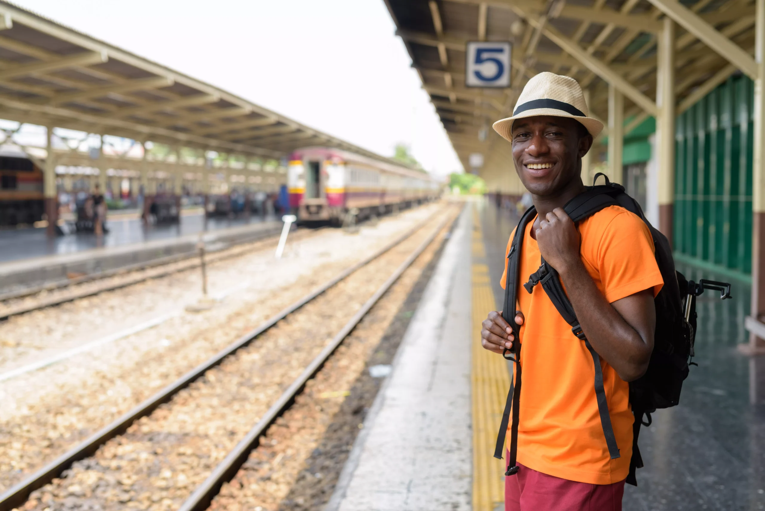 happy-young-african-tourist-man-smiling-while-wait