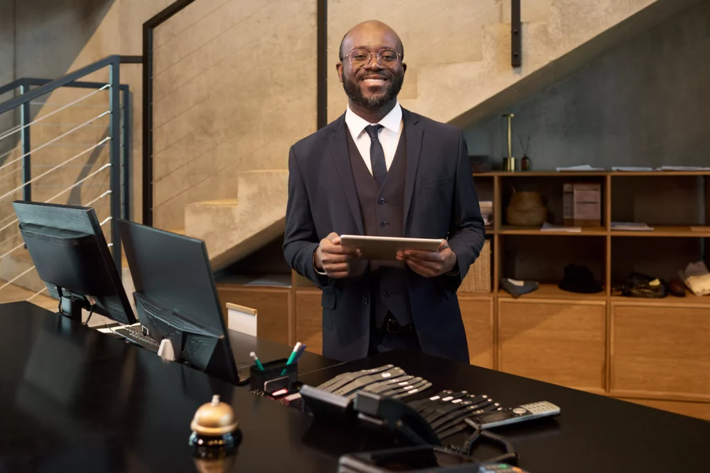 smiling-businessman-standing-in-modern-office-hold