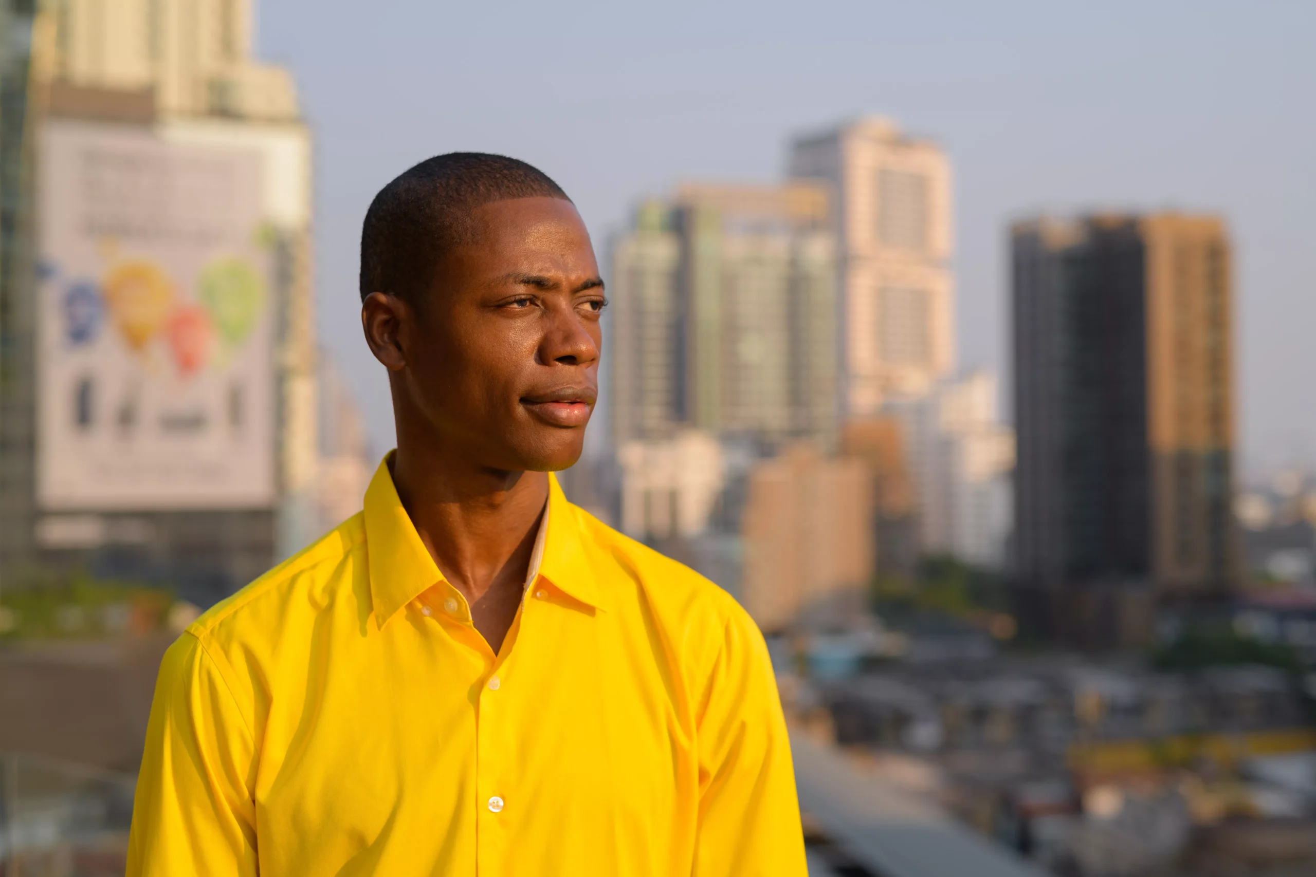 young-thoughtful-bald-african-businessman-against